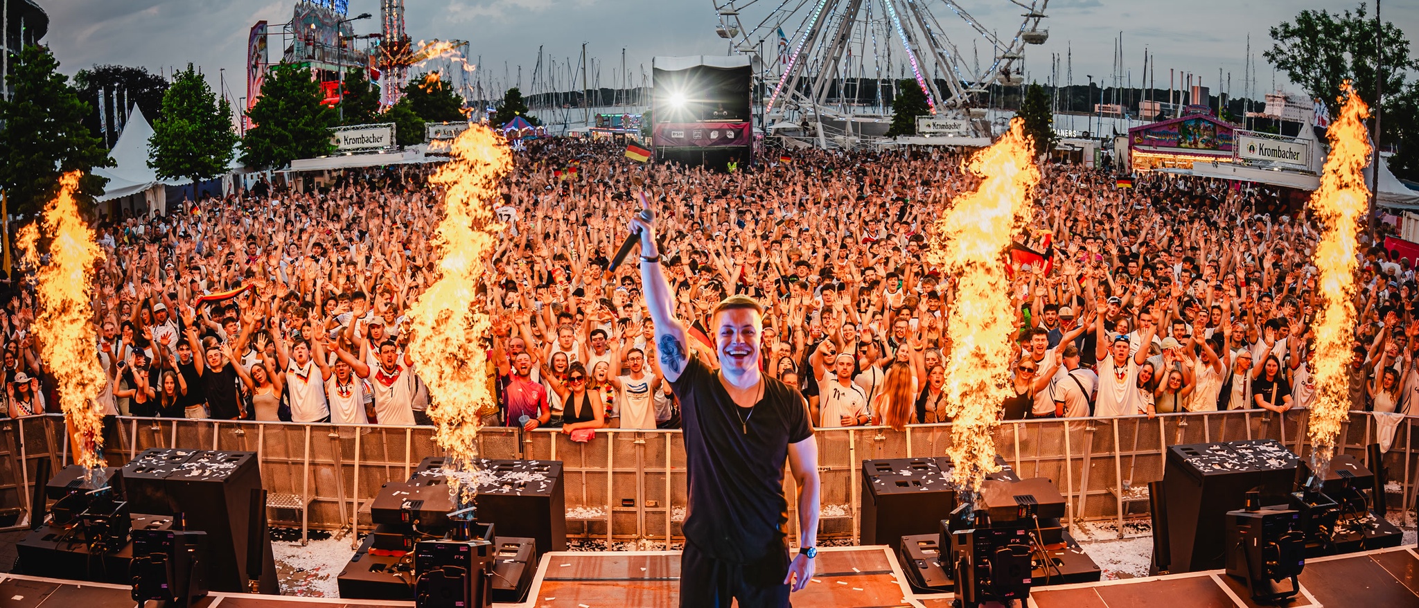 TISCORE on a festival mainstage with pyro fountains in front of a packed crowd